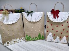 three brown bags decorated with christmas trees and bows