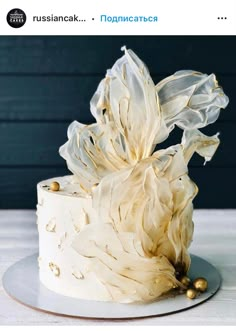 a white cake with gold decorations on top