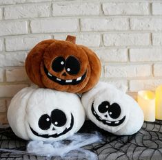 two jack - o'- lantern pumpkins sitting on top of each other