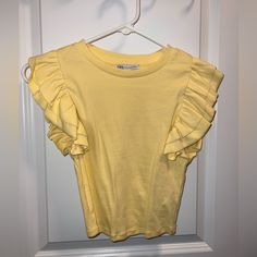 This Tip Has Never Been Worn And Is In Perfect Condition. Material Is Great And Very Stretchy. Fits Perfect And Is Super Cute! Stretch T-shirt With Ruffle Sleeves For Summer, Spring Crew Neck Tops With Ruffles, Trendy Ruffled T-shirt For Spring, Spring Ruffled Crew Neck Tops, Yellow Stretch Zara Top, Spring T-shirt With Ruffle Sleeves And Details, Chic Ruffled T-shirt For Spring, Spring Ruffle Sleeve Stretch T-shirt, Zara Yellow Crew Neck Top