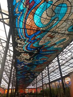 the inside of a building with many stained glass windows