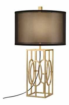 a table lamp with a black shade on the top and a gold frame around it