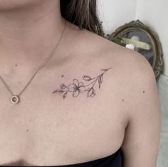 a woman with a flower tattoo on her chest