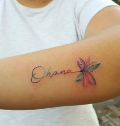 a person with a tattoo on their arm that says, ohana in cursive writing