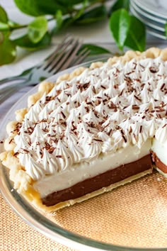 a chocolate and cream pie on a glass plate