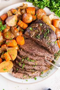 a white plate topped with steak, potatoes and carrots