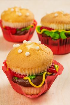 three cupcakes that have been made to look like hamburgers