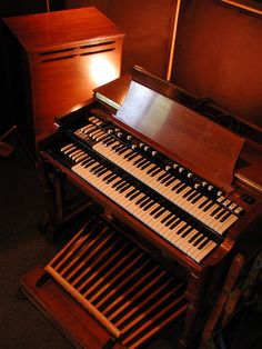 an old pipe organ sitting in front of a dresser