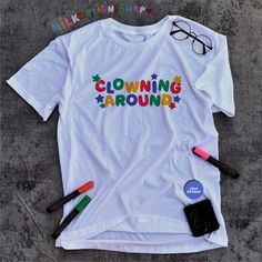 This clowncore shirt is the perfect funny meme shirt to wear as your clown statement tee. Inspired by the colorful clowncore clothing - this clown shirt can be a great addition to your clowncore clothes for simpler days. It's a funny gift for her, funny gift for him or anyone in between as these colorful clowncore shirt are unisex. Available in XS, S, M, L, XL, 2XL, & 3XL ✨ 100% ⭐️ PREMIUM ⭐️ Airlume combed and ringspun cotton  ✨ Light fabric ✨ Retail Unisex fit ✨ Tear away label ✨ Runs true to Clowncore Clothes, Clowncore Shirt, Kidcore Shirt, Clowncore Fashion, Weirdcore Outfits, Clown Oc, Kidcore Clothing, Clown Shirt, Silly Clothes