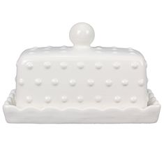 a white cake dish with dots on it