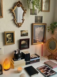 a white desk topped with lots of books and pictures