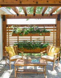 an outdoor living area with wooden furniture and plants