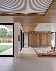 a living room filled with furniture and wooden walls