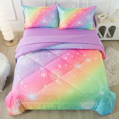 a bed with colorful comforters and pillows