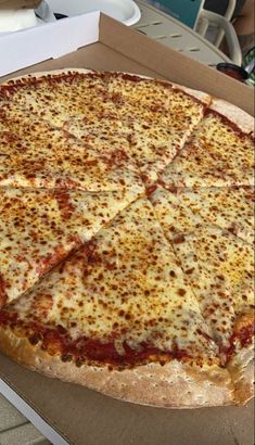 a large pizza sitting on top of a cardboard box