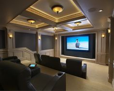 a home theater with chairs and a projector screen