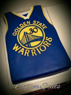 a cake that is shaped like a golden state warriors jersey