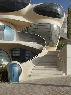 an unusual house with stairs leading up to it