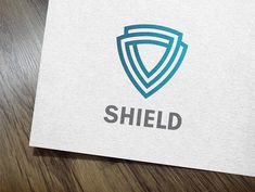 the shield logo is displayed on a piece of paper