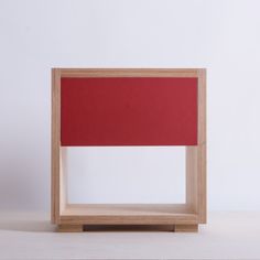 a red piece of furniture sitting on top of a table