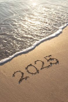 the word 2009 is written in the sand at the beach