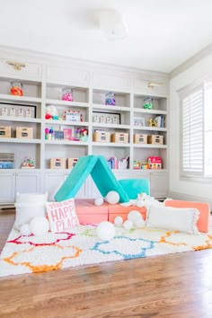 a living room filled with furniture and bookshelves next to a large white book shelf