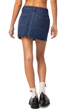 This cute miniskirt is made with nonstretch denim and designed with a raw hem for authentic vibes. Zip fly with button closure Coin pockets; front slant pockets; back patch pockets 100% cotton Machine wash, line dry Imported Dark Wash Cotton Mini Skort, Cutoff Mini Skirt With Pockets, Dark Wash Cotton Denim Mini Skirt, Dark Wash Cotton Mini Skirt, Dark Wash Cotton Mini Skirt With Pockets, Dark Wash Cotton Mini Denim Skirt, Trendy Mini Cotton Bottoms, Spring Mini Denim Skort, Blue Cotton Cutoff Mini Skirt