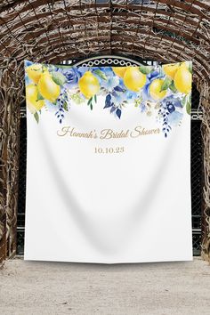 a wedding banner with lemons and blue flowers on it is hanging in an archway