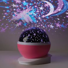 a night light with stars and a dragon on it's head is shown in front of a purple background