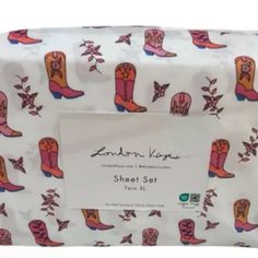 a white bag with pink and orange cowboy boots printed on it's front side