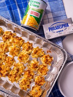 a pan filled with food next to a can of green giant cornbreads on top of a blue and white checkered table cloth