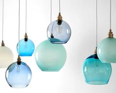 five different colored glass pendants hanging from the ceiling