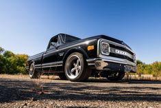 an old pickup truck parked on the side of the road