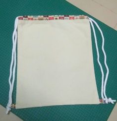 a white bag sitting on top of a green mat