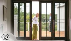 a woman standing in front of a glass door