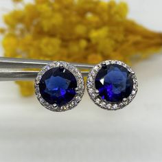 Vintage Sterling Silver Blue Sapphire & White Topaz Halo Earrings...Marked 925...Total of weights 4.5grams...Measure of stone center 8MM... These are in very good condition. Blue Jewelry With Round Cut Gemstone Accents, Blue Sapphire Jewelry With Halo Design, Blue Sapphire Earrings For Anniversary, Sapphire Gemstones With Sterling Silver, Cubic Zirconia Earrings With Accent Stones, Sapphire Jewelry With Halo Design, Sapphire Gemstones In Sterling Silver, Blue Gemstones With Halo Setting For Anniversary, Blue Sapphire Earrings In Fine Jewelry Style