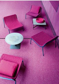 pink chairs and tables are arranged on the floor