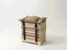 a bag sitting on top of a stack of books with straps around the bottom and sides