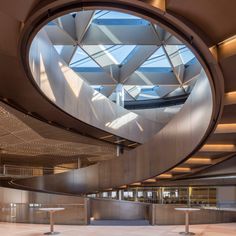 the inside of an empty building with metal railings and circular glass windows on the ceiling