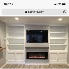 a fireplace with built in bookshelves and a flat screen tv mounted on the wall