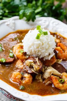 a white plate topped with rice and shrimp