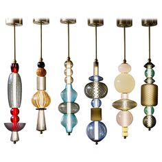 a bunch of different colored glass objects hanging from a ceiling fixture in various shapes and sizes