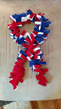 red, white and blue streamers are arranged in the shape of an x on a bed