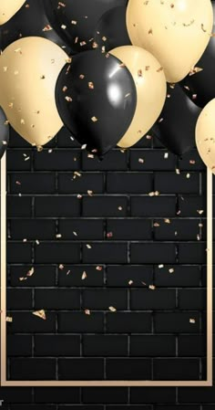 black and white balloons with gold confetti in front of a dark brick wall