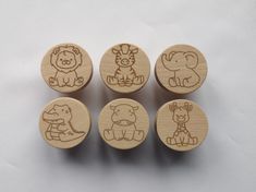 four wooden stamps with animals on them