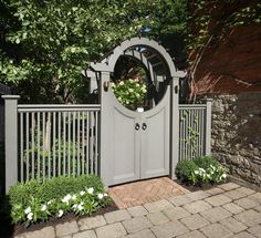 a white gate with a round mirror on it