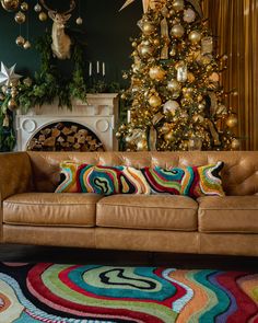 a living room filled with furniture and a christmas tree in the backgroung