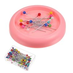 a pink tray with pins and needles in it