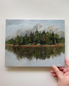 a painting of a lake with trees in the background