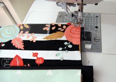 the sewing machine is next to some fabric